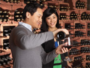Asian couple tasting wine